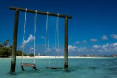 View of swings overwater in the Soneva Jani lagoon